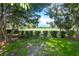 Scenic view of lush green landscaping and trees, enhancing the property's natural beauty and curb appeal at 9 Pelican Pl, Belleair, FL 33756