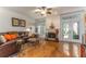 Cozy living room featuring a leather sofa, fireplace, and hardwood flooring at 9 Pelican Pl, Belleair, FL 33756