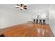Spacious living area with hardwood flooring, open concept, and barstool seating at 9 Pelican Pl, Belleair, FL 33756