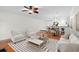 Open living space with hardwood floors, ceiling fan, and stylish contemporary furniture at 9 Pelican Pl, Belleair, FL 33756