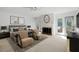 Bright main bedroom with sitting area, fireplace, ceiling fan, and balcony access at 9 Pelican Pl, Belleair, FL 33756