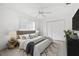 Cozy bedroom features a plush bed, ceiling fan and ample closet space at 9 Pelican Pl, Belleair, FL 33756