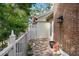 Inviting patio area featuring brick flooring and charming landscaping for relaxation and outdoor enjoyment at 9 Pelican Pl, Belleair, FL 33756