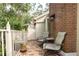 Charming brick patio with outdoor seating area and lush greenery, perfect for relaxation at 9 Pelican Pl, Belleair, FL 33756