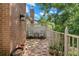 Secluded brick paver patio with privacy fencing and outdoor seating at 9 Pelican Pl, Belleair, FL 33756