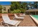 Relaxing pool area with lounge chairs and brick pavers at 9 Pelican Pl, Belleair, FL 33756
