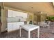 Outdoor pool house featuring a kitchenette, dining area, and ceiling fans at 9 Pelican Pl, Belleair, FL 33756