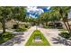 Beautiful community street with tree-lined streets, lush lawns, and well-maintained townhomes at 9 Pelican Pl, Belleair, FL 33756
