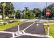 Street view of crosswalk and stop sign in quiet neighborhood at 9 Pelican Pl, Belleair, FL 33756