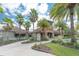 Community clubhouse with palm trees and landscaping at 1767 Tonka Ter, Wesley Chapel, FL 33543