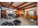 Mid-century modern living room with open floor plan, exposed beams, and terrazzo flooring at 11921 Lagoon Ln, Treasure Island, FL 33706