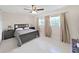 Spacious bedroom with a double bed, ceiling fan, and large windows at 1385 Embassy Dr, Clearwater, FL 33764