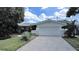 Ranch-style home with a large driveway and well-maintained lawn at 1385 Embassy Dr, Clearwater, FL 33764