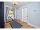 Light and airy hallway with two doors and wood floors at 6619 Livingston N Ave, St Petersburg, FL 33702