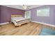 Primary bedroom with king-size bed and wood flooring at 6619 Livingston N Ave, St Petersburg, FL 33702