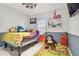 Softball-themed bedroom with a queen bed, and floating shelves at 1905 Masters Way, Plant City, FL 33566