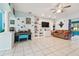 Living area with tiled floors, built-in shelving and a TV at 1905 Masters Way, Plant City, FL 33566