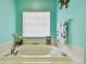Relaxing bathroom with a large soaking tub and light-colored tile at 1905 Masters Way, Plant City, FL 33566
