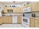 Modern kitchen with white appliances and cabinets at 1905 Masters Way, Plant City, FL 33566