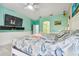 Bright bedroom with a large bed, TV, and light-colored wood floors at 1905 Masters Way, Plant City, FL 33566