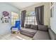 Serene bedroom with gray sectional and rocking chair at 1905 Masters Way, Plant City, FL 33566