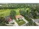 Aerial view of two-story house with a large backyard and surrounding trees at 1905 Masters Way, Plant City, FL 33566
