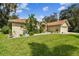Tan one-story house with lush landscaping and a two-car garage at 1905 Masters Way, Plant City, FL 33566