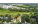 Aerial view showing a house nestled in a lush green landscape, near industrial buildings at 1905 Masters Way, Plant City, FL 33566