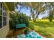 Relaxing patio area with teal bench and lush landscaping at 1905 Masters Way, Plant City, FL 33566