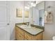 Clean bathroom with single sink vanity, mirror, and linen towel rack at 1905 Masters Way, Plant City, FL 33566