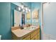 Light-blue bathroom with a single sink vanity and built-in cabinets at 1905 Masters Way, Plant City, FL 33566