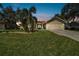 Tan two-story house with a two-car garage and well-manicured lawn at 1905 Masters Way, Plant City, FL 33566