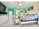 Spacious bedroom with light wood floors, a ceiling fan, and a large TV at 1905 Masters Way, Plant City, FL 33566
