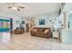 Living room with brown couch and view into kitchen at 1905 Masters Way, Plant City, FL 33566