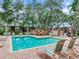 Inviting community pool with lounge chairs and brick patio at 2669 Sequoia Ter, Palm Harbor, FL 34683