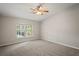 Spacious bedroom with plush carpeting and large window at 3011 Folklore Dr, Valrico, FL 33596