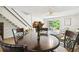 Bright dining area with a round table and four chairs, near the living room and kitchen at 1655 58Th S Ter # 1, St Petersburg, FL 33712
