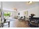 Living room with patio access, featuring a sofa, chairs, and a dining table at 1655 58Th S Ter # 1, St Petersburg, FL 33712