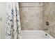 Bathroom with a shower/tub combo and tile surround at 1655 58Th S Ter # 1, St Petersburg, FL 33712