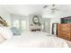 Bright bedroom with a king-size bed, fireplace and private balcony access at 9 Pelican Pl, Belleair, FL 33756