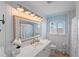 Bright bathroom with white vanity and shiplap walls at 1505 Sea Gull S Dr, St Petersburg, FL 33707