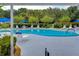 Inviting community pool with lounge chairs and umbrellas at 3843 Damian Dr, Zephyrhills, FL 33541