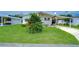 Single-wide home with carport and well-maintained lawn at 3843 Damian Dr, Zephyrhills, FL 33541