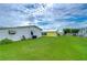 Large grassy backyard with multiple manufactured homes visible at 3843 Damian Dr, Zephyrhills, FL 33541