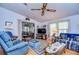 Cozy living room featuring comfy seating, a TV, and a charming window view at 3843 Damian Dr, Zephyrhills, FL 33541