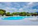 Relaxing kidney-shaped pool with plenty of lounge chairs at 3843 Damian Dr, Zephyrhills, FL 33541