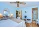 Main bedroom with a dresser, a large bed, and ensuite bathroom at 3843 Damian Dr, Zephyrhills, FL 33541