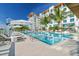 Resort-style pool with comfortable lounge chairs and umbrellas at 1028 Sunset Point Rd # R10, Clearwater, FL 33755