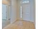 Bright entryway with tile floor and white doors at 7110 Moss Ledge Run, Land O Lakes, FL 34637