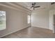 Main bedroom with wood-look floors and large window at 7110 Moss Ledge Run, Land O Lakes, FL 34637